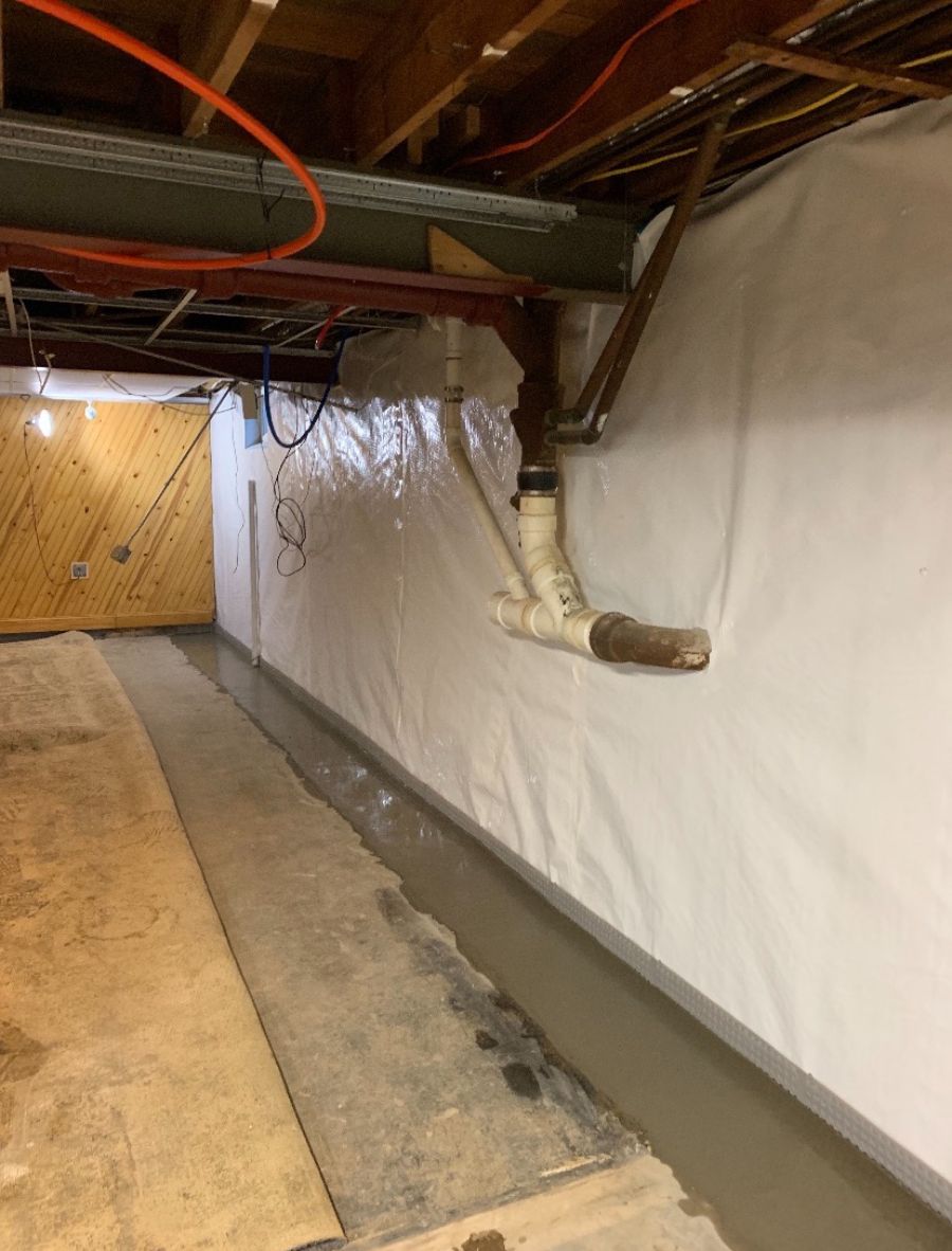 basement wall, ceiling with exposed pipes