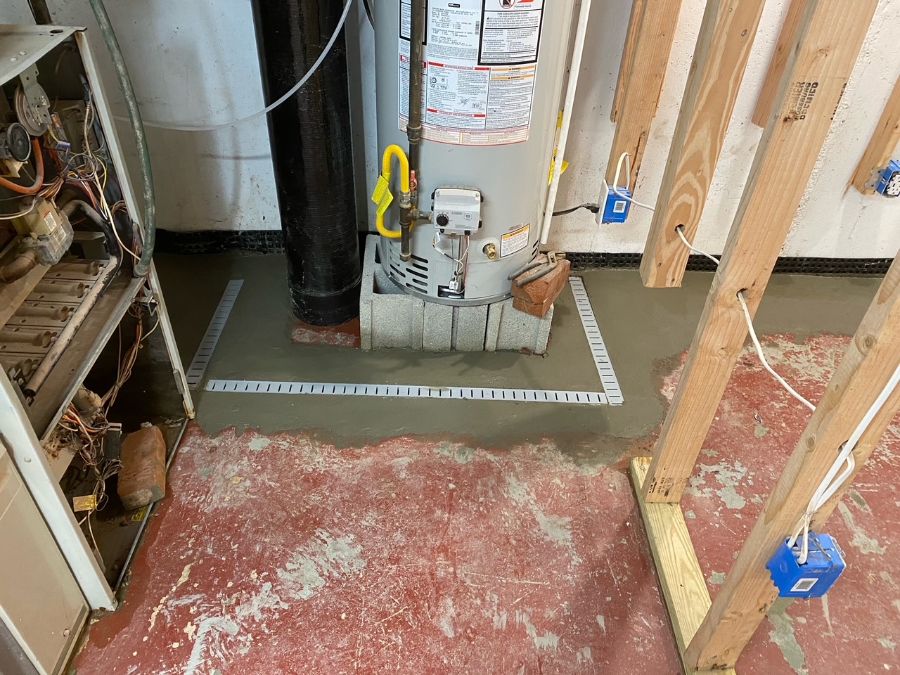 basement hot water heater on concrete floor